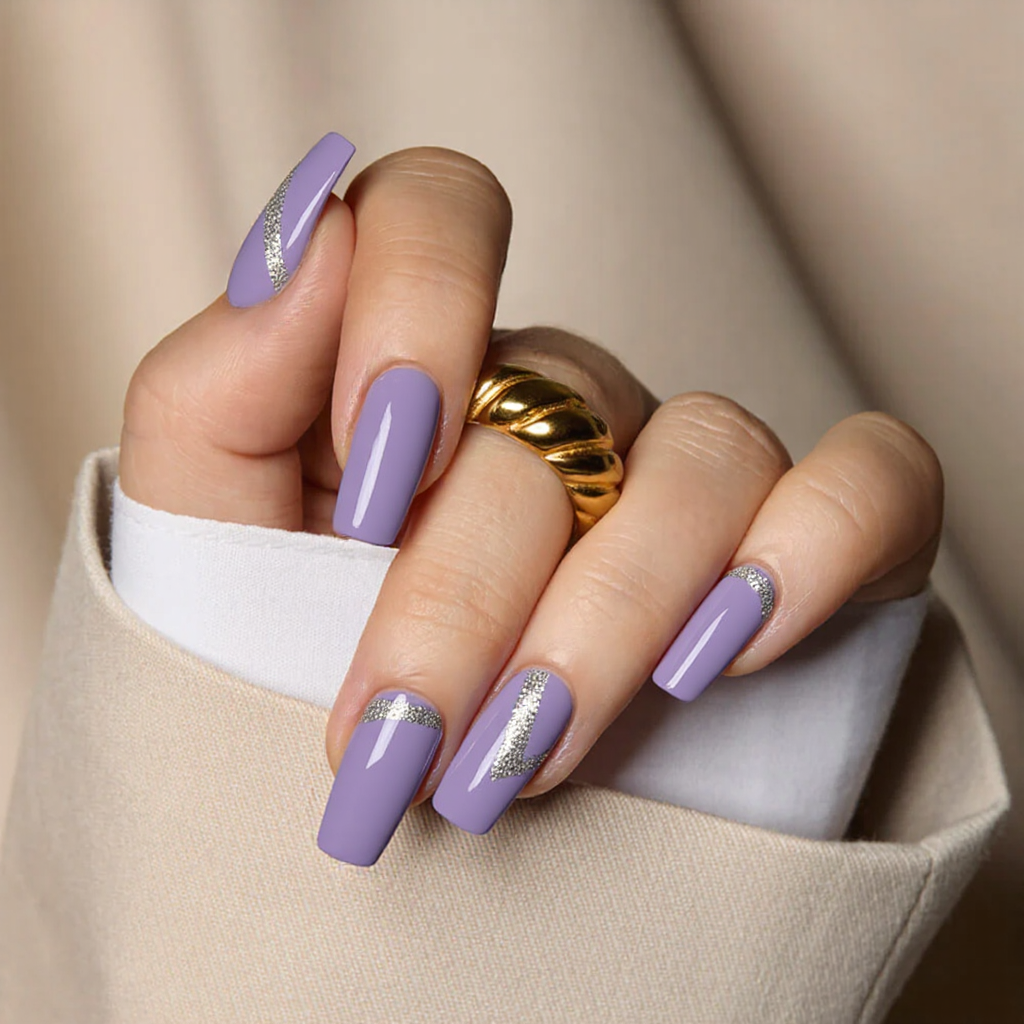 Medium square nails in a lilac base, each featuring a thin silver glitter stripe along the tips.