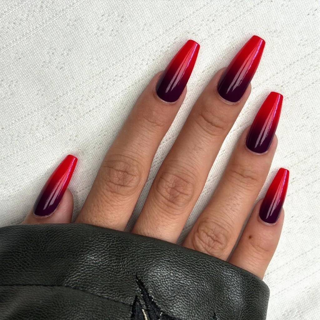 Long stiletto nails featuring a vibrant ombre from bright red to deep burgundy for a bold statement.
