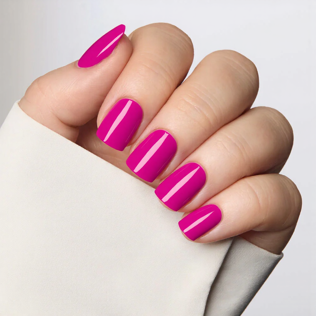 Short square nails in a vibrant fuchsia, keeping it simple and glossy for a quick pop of color.