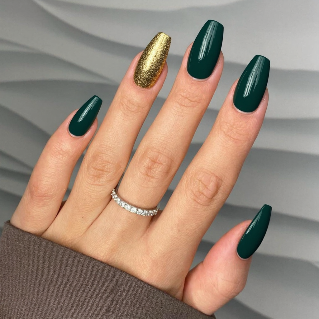 Long almond nails in a forest green, and let's add a bit of gold foil near the tips for a festive winter look.