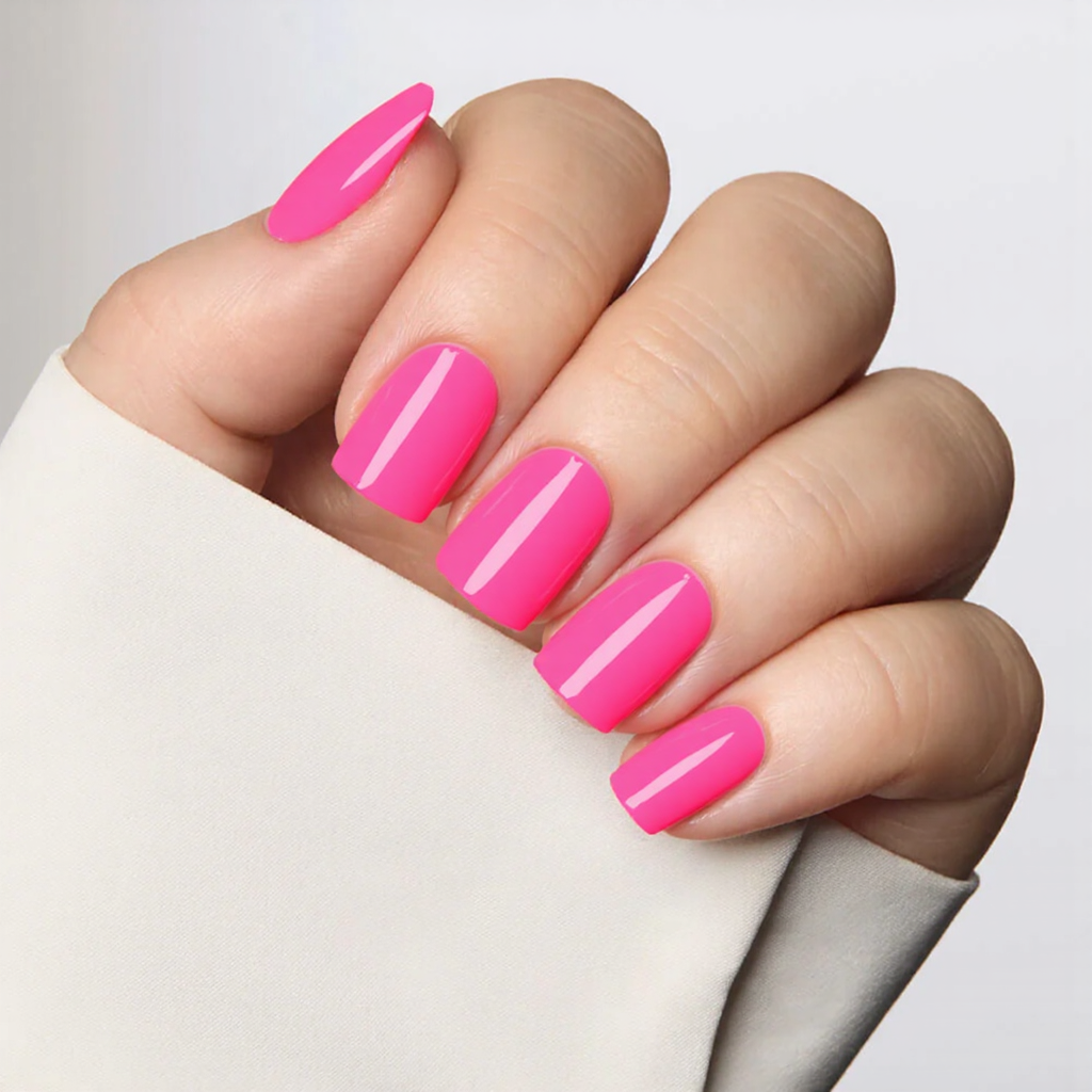 Short square nails in a modern French tip, where the tip is angled diagonally in a bright neon color.