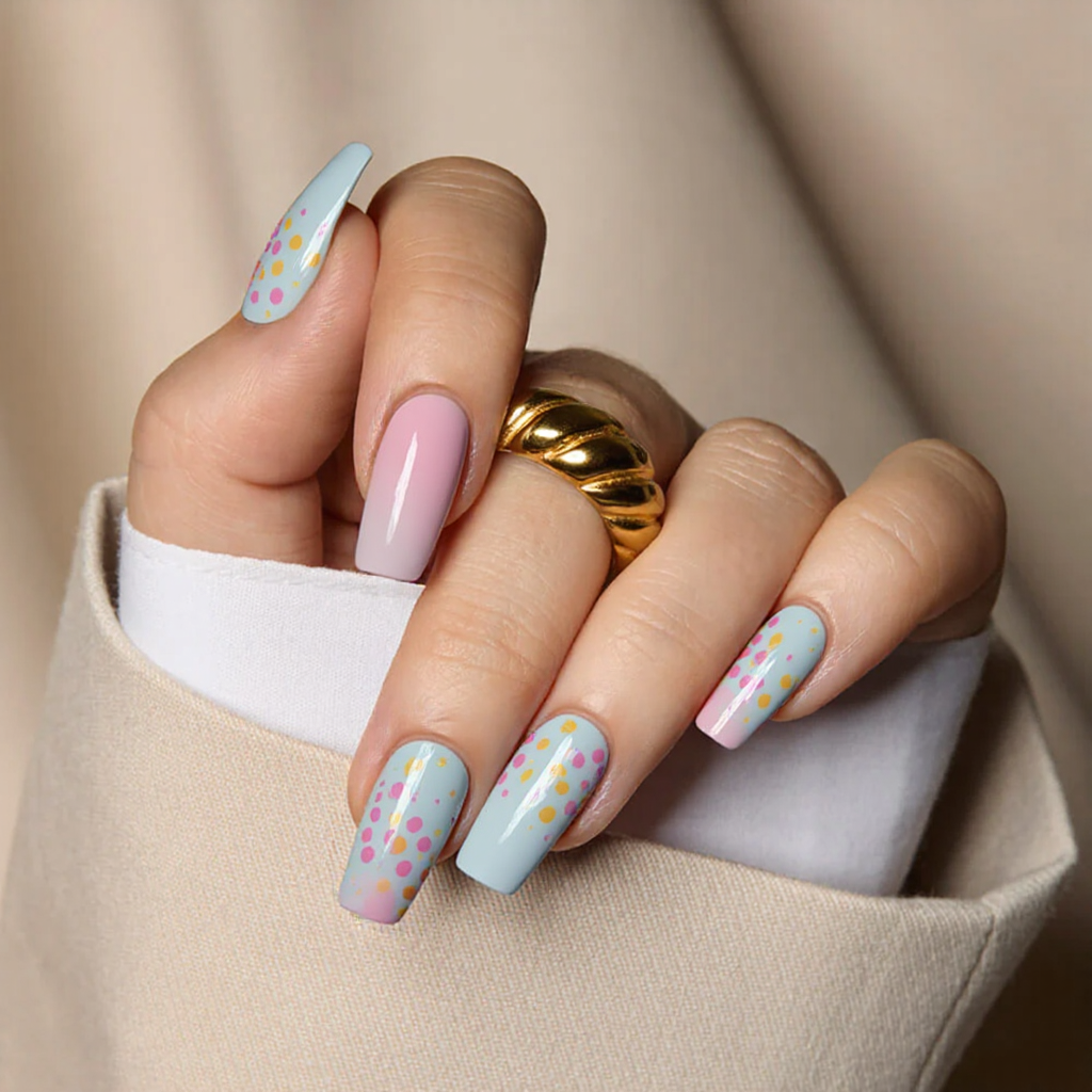 Medium square nails in pastel shades, each with a different polka-dot nail art arrangement.