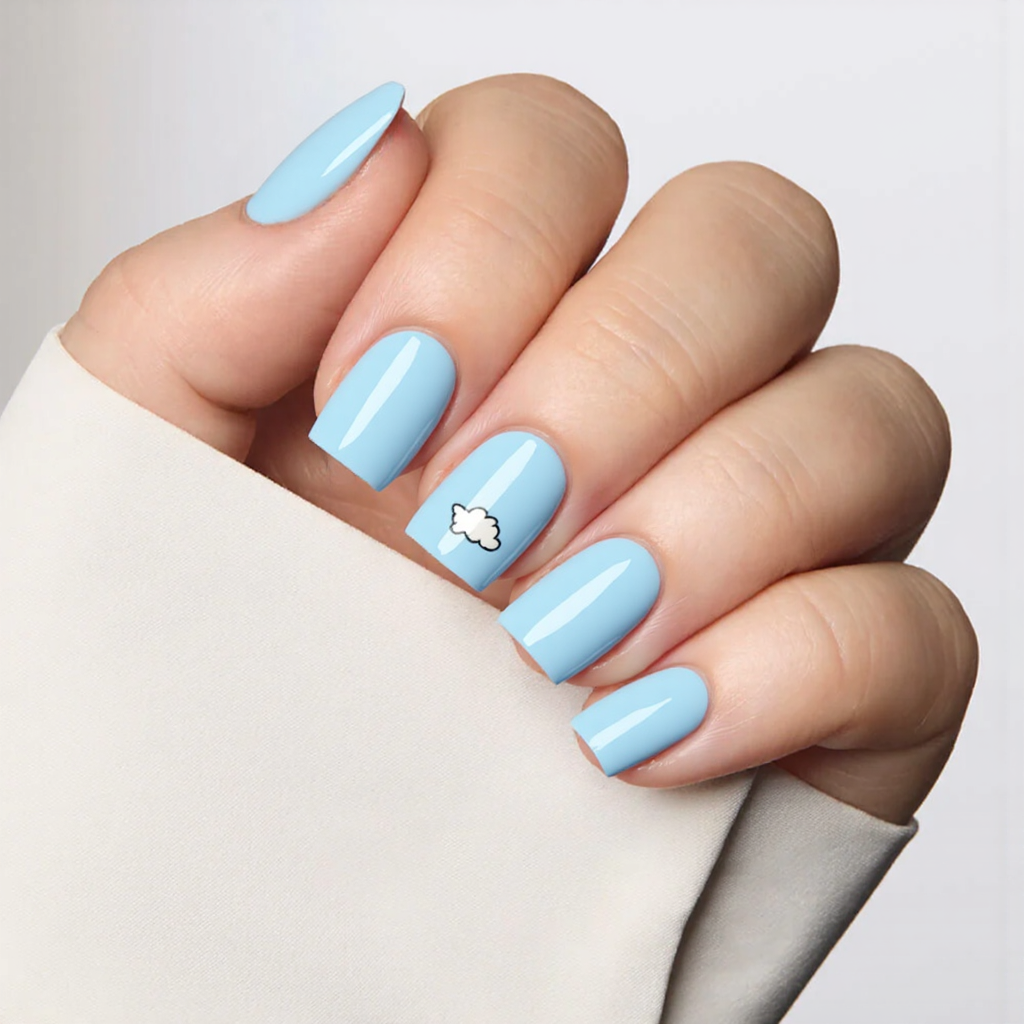 Short square nails in baby blue, each with a small cloud design on the ring finger for a cute touch.