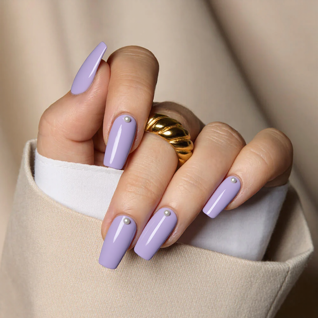 Medium square nails with angled French tips in pastel purple, adding a tiny pearl at each tip.