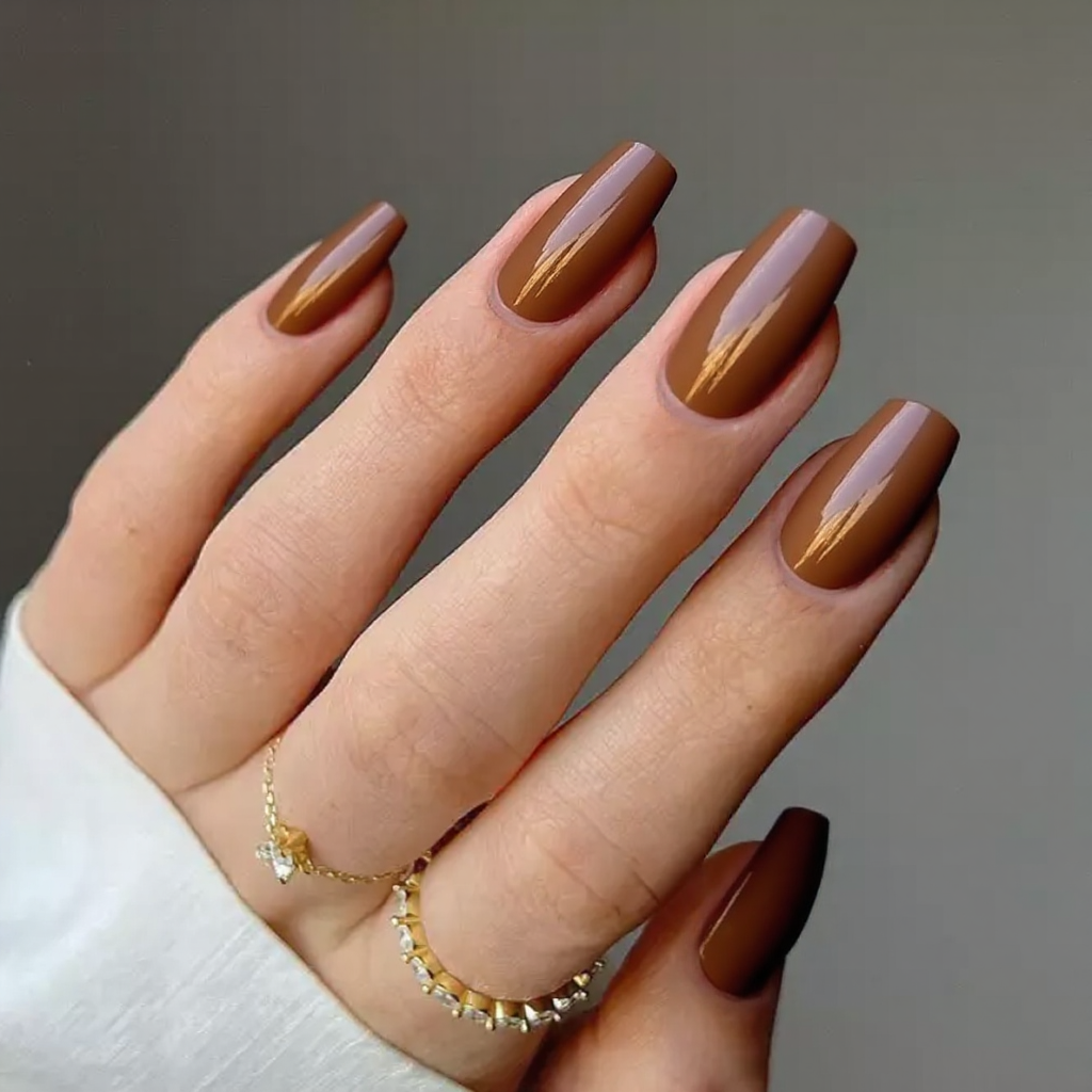 Medium stiletto nails in a mocha-to-caramel ombre, ideal for a warm, natural look.