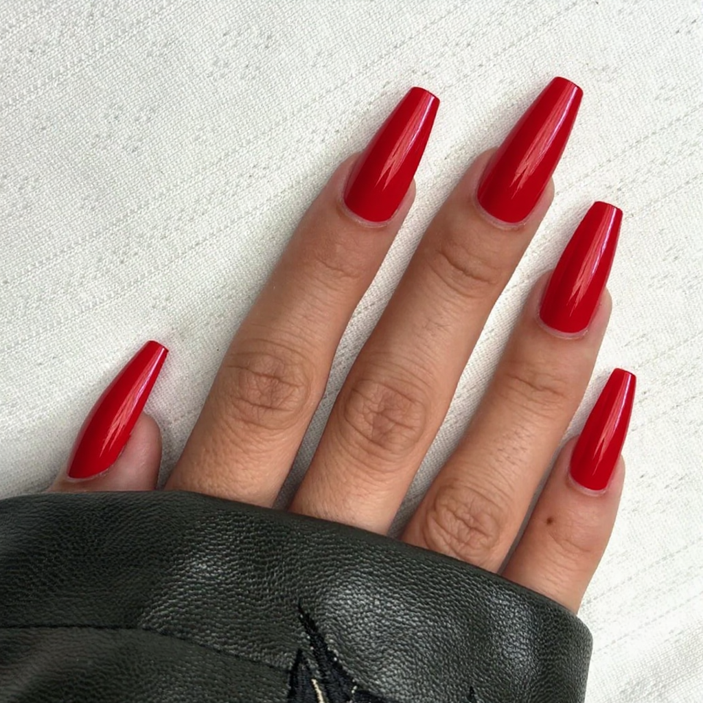Long stiletto nails in a classic glossy red—perfect for a straightforward, timeless look.