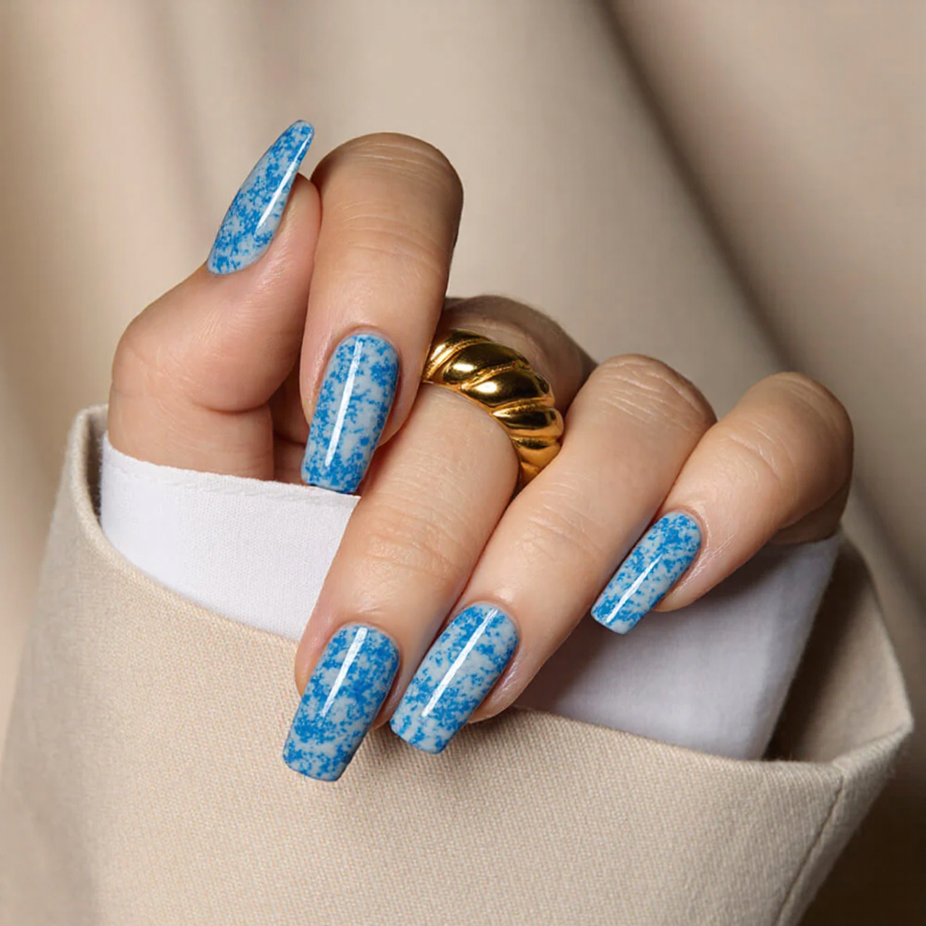 Medium square nails in a marbleized blue-and-white pattern, perfect for a breezy, coastal vibe.