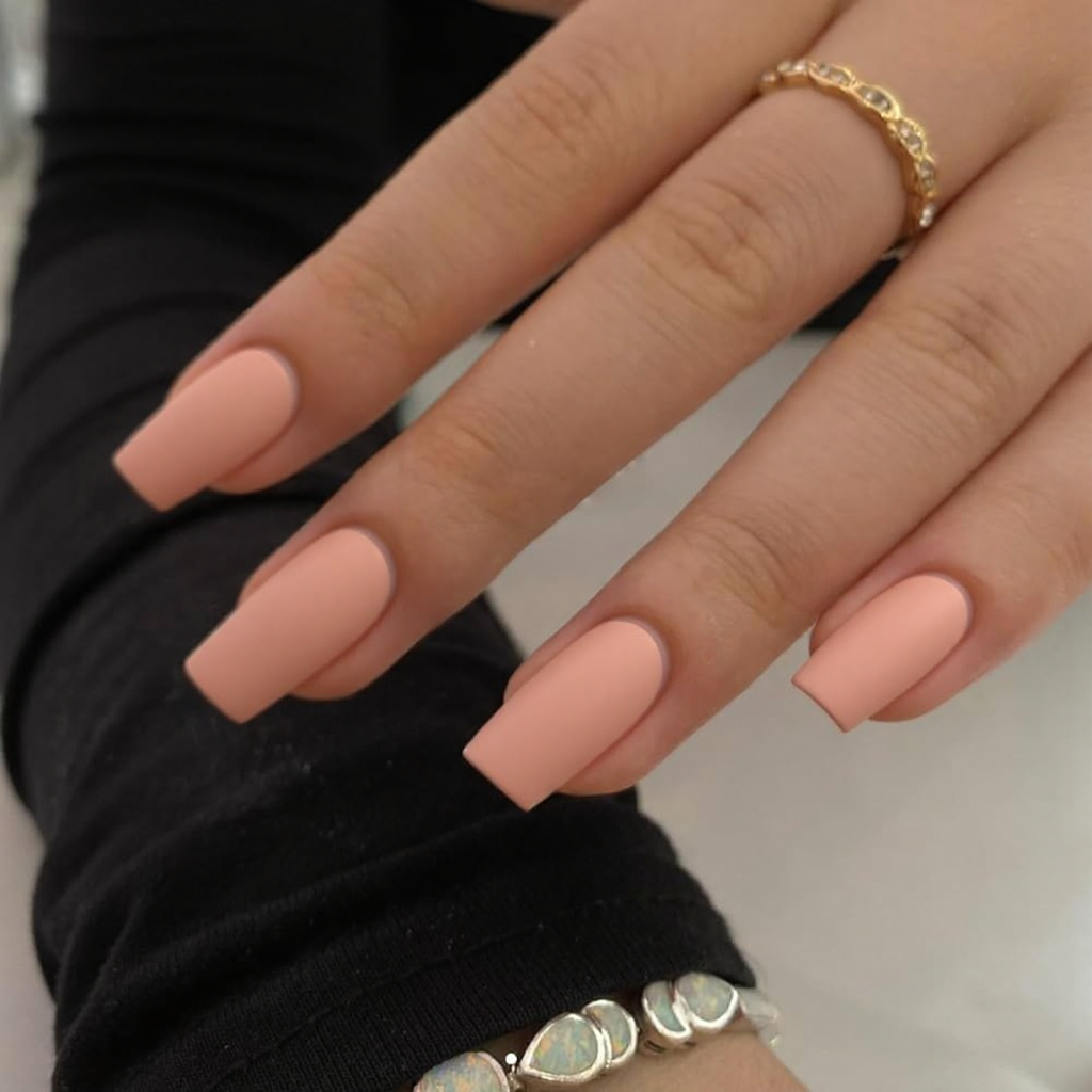 Short stiletto nails in a matte peach, super easy to apply and looks put-together.