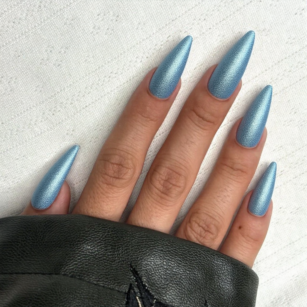 Long stiletto nails in a shimmering ice blue, perfect for reflecting the chilly January weather.