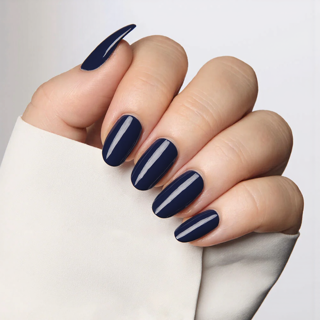 Medium almond nails in a deep navy blue, maybe add a thin silver stripe along the tips for contrast.