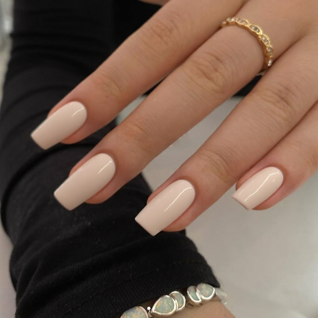 Short stiletto nails in a creamy off-white color, super clean and minimal.