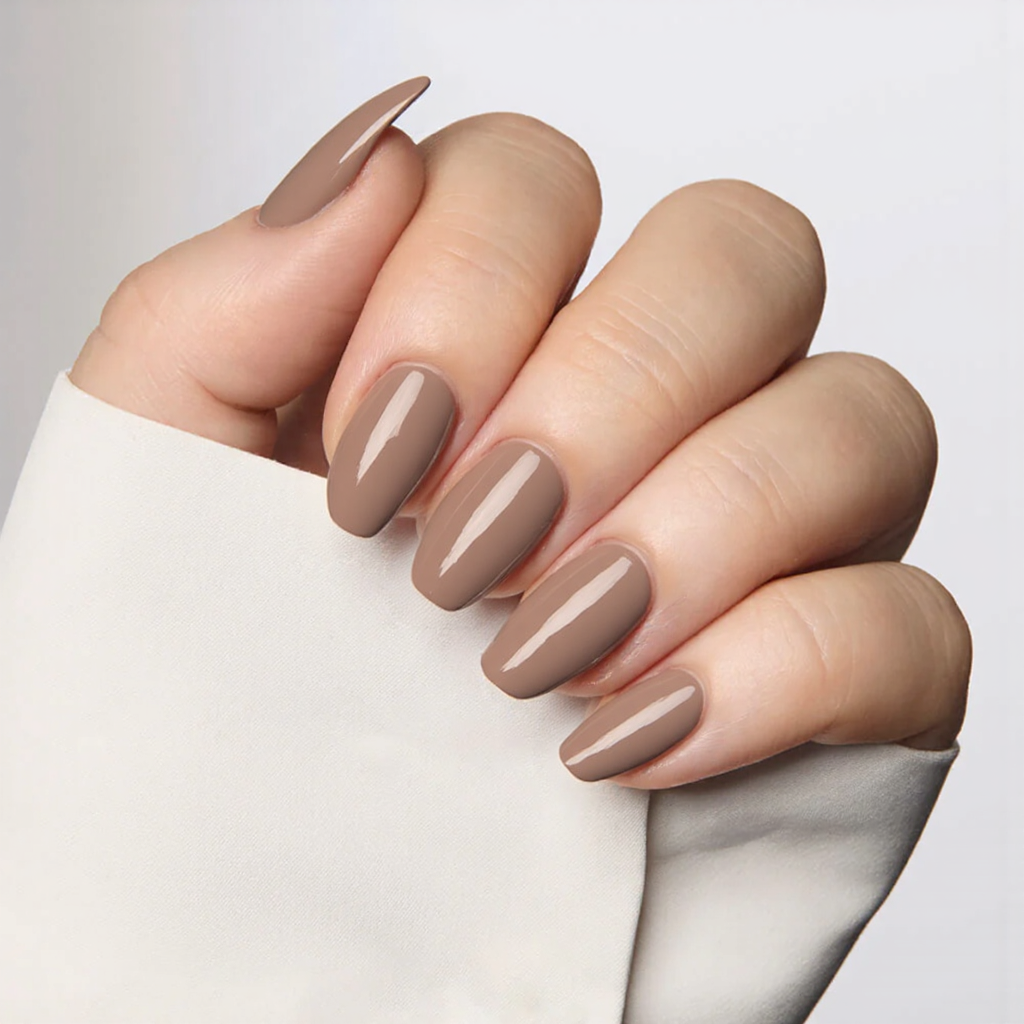 Medium almond nails in taupe, each with a thin diagonal white stripe for a simple, clean look.