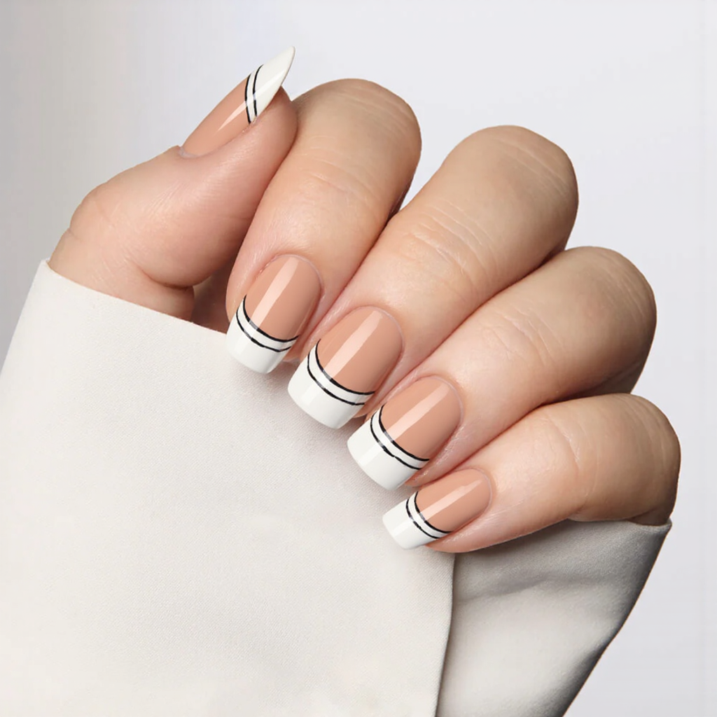 Medium almond nails with a crisp white base and a delicate black outline on each tip for a modern vibe.