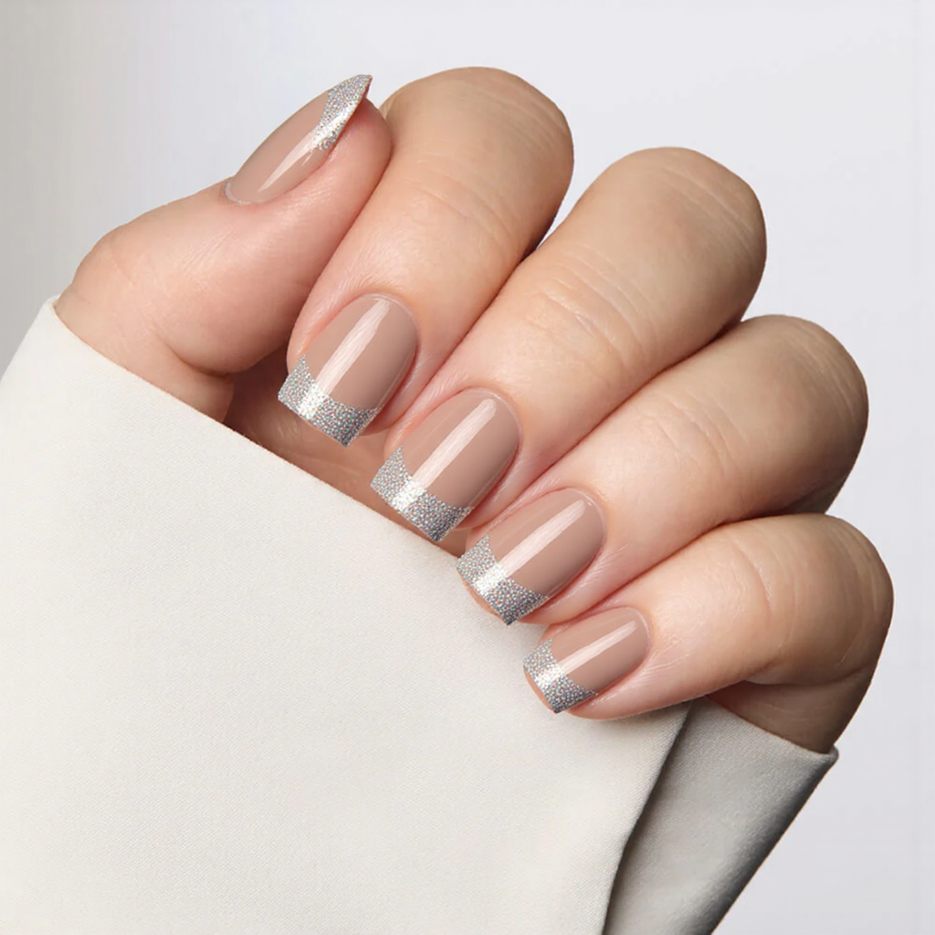Short square nails in a translucent nude with holographic glitter tips, offering a subtle yet futuristic 2025 style.