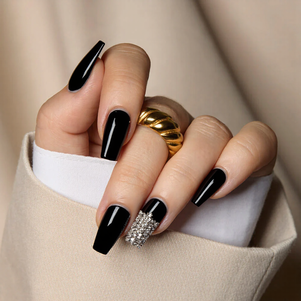 Medium square nails in black with a small rhinestone cluster at the base of the ring finger.
