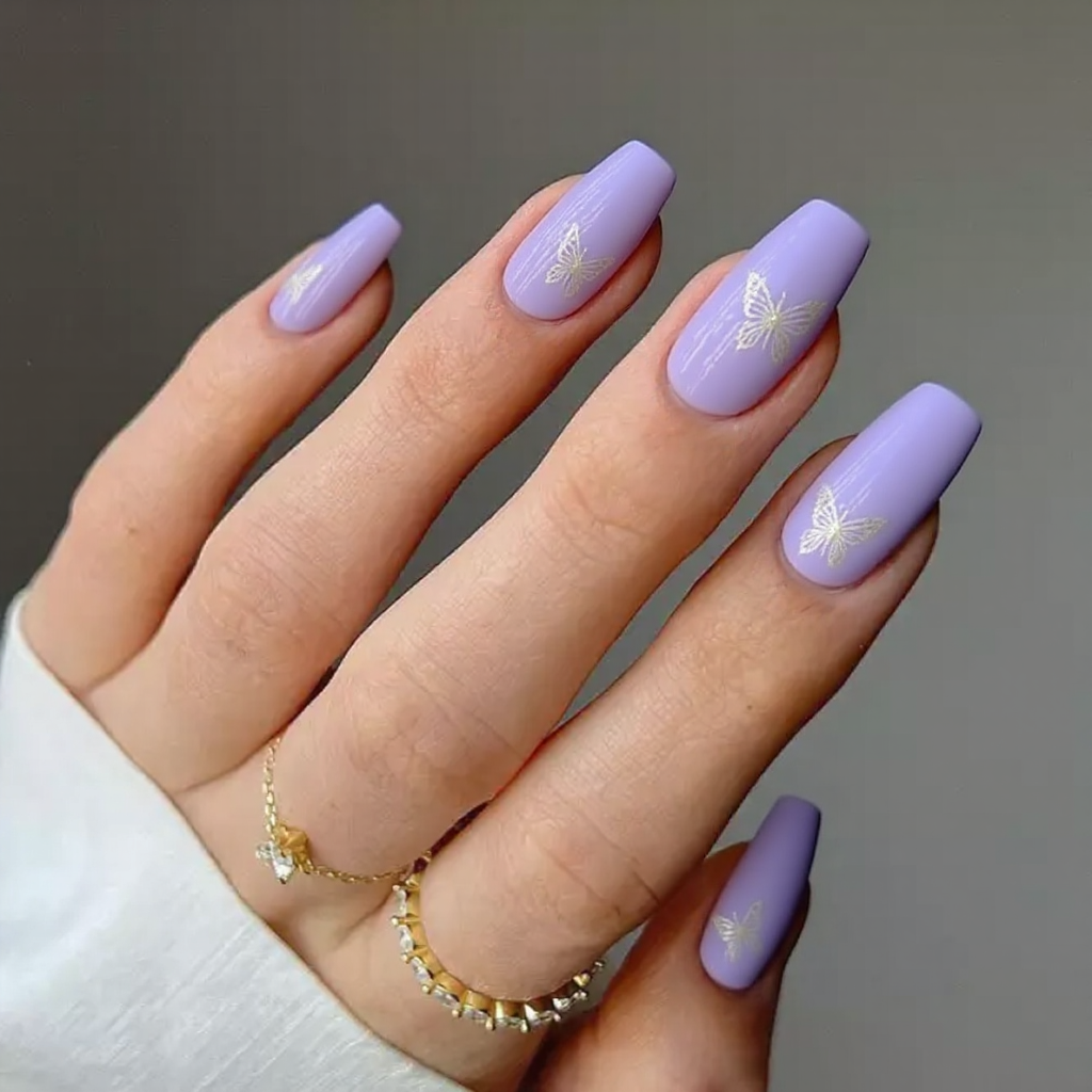 Medium stiletto nails in lavender with delicate butterfly silhouettes on a couple of nails for a spring look.