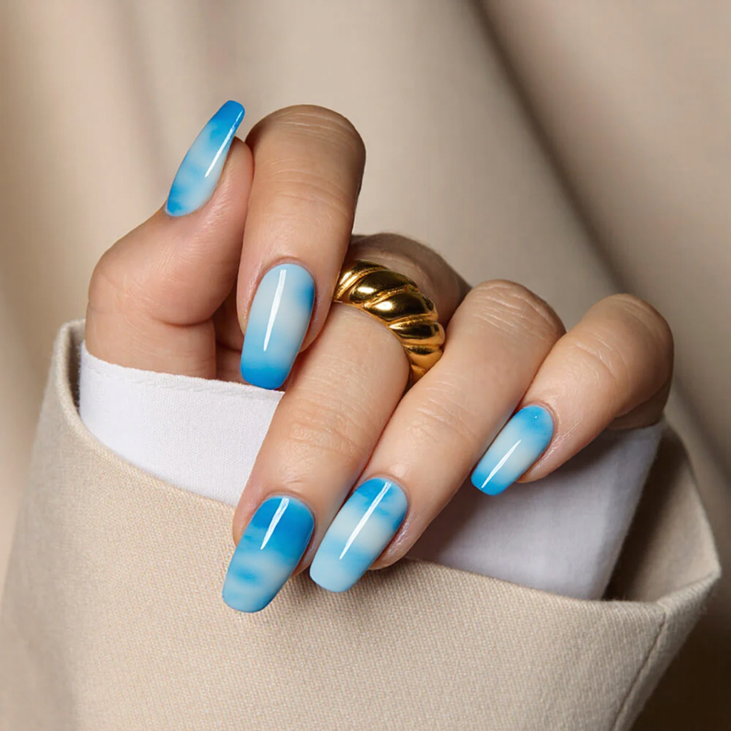 Medium square nails featuring a blue to white ombre effect, giving a fresh and breezy summer vibe.