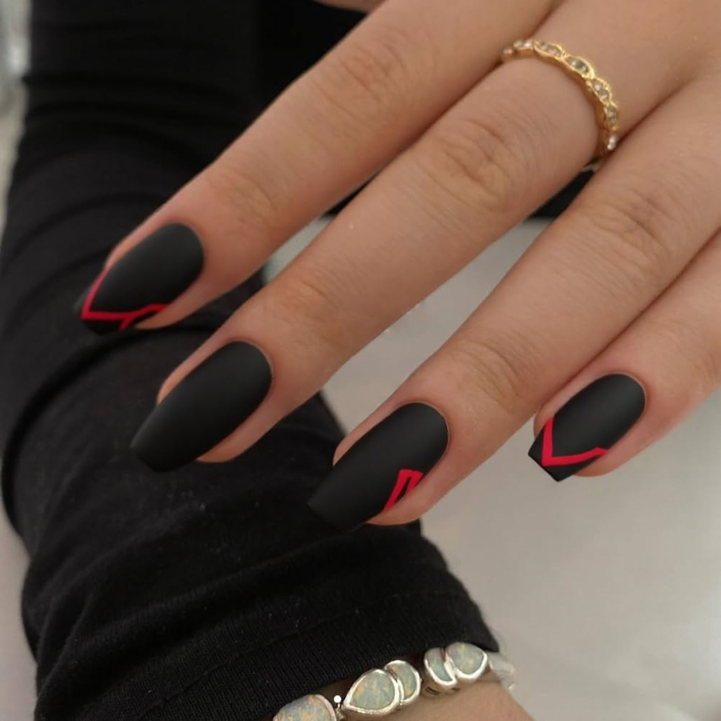 Short stiletto nails in a matte black with a single red stripe for an edgy yet romantic February look.