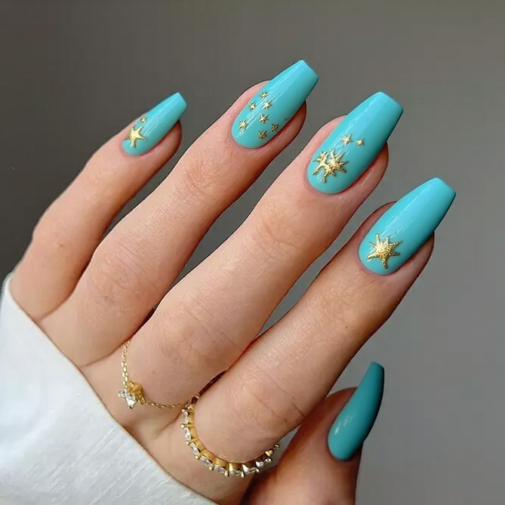 Medium stiletto nails in a vibrant aqua with tiny starfish accents for a fun poolside look.