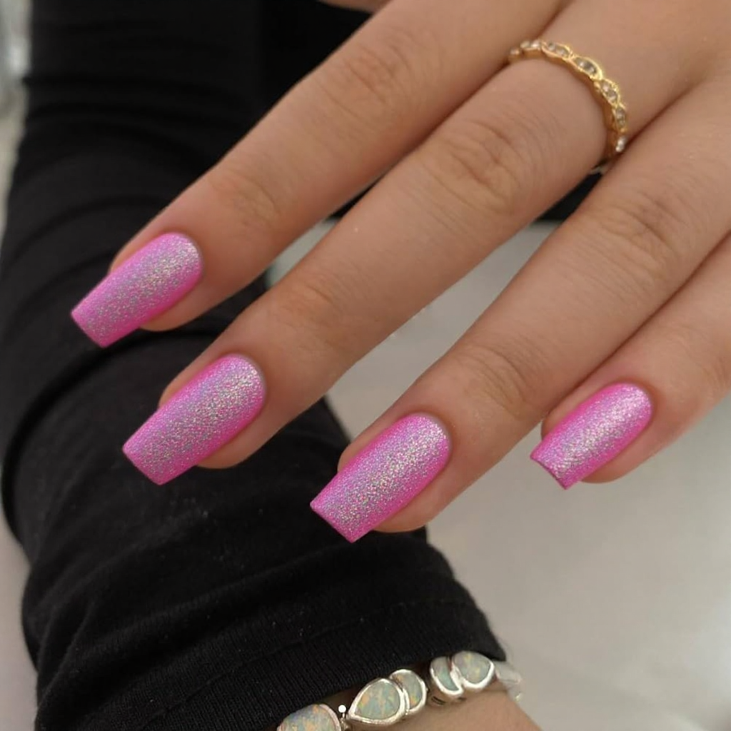 Short stiletto nails in a bright holographic pink, perfect for making a bold statement in 2025.