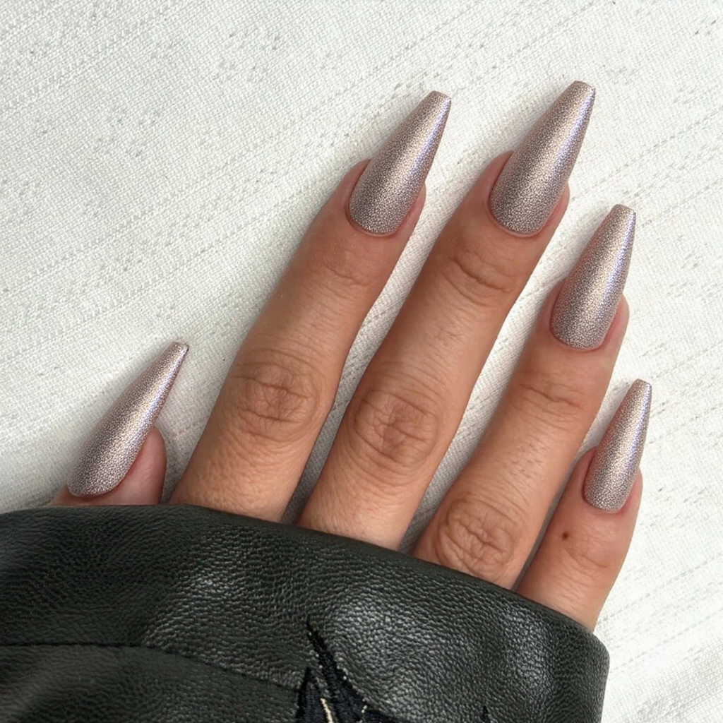 Long stiletto nails with an elegant French tip, plus a subtle glitter fade at the base for some sparkle.
