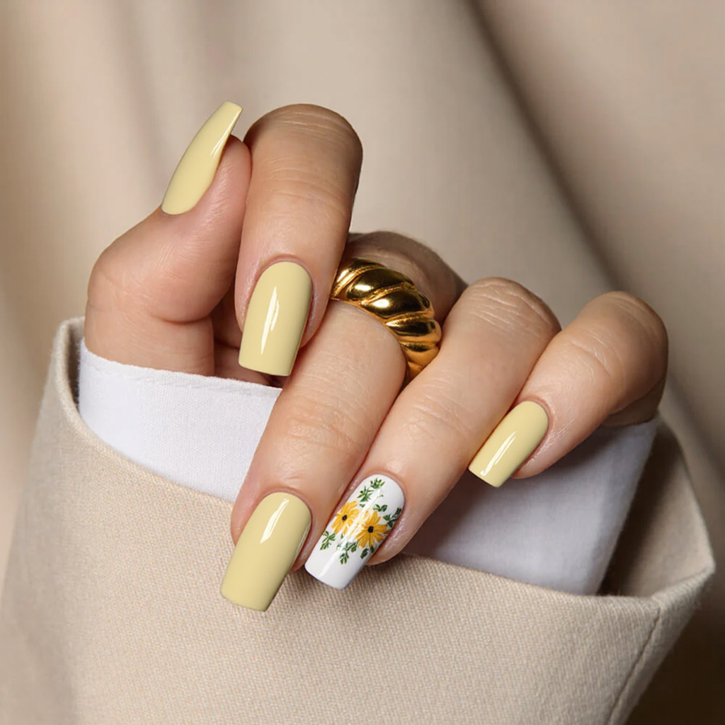 A medium square manicure with a pastel yellow base and a single floral accent nail sounds perfect for spring.