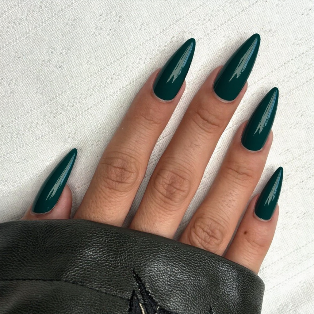 Long stiletto nails in a deep emerald green, perfect for a bold statement.