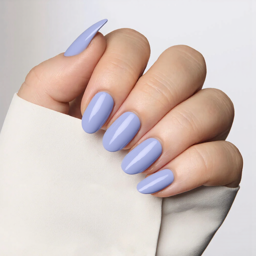Medium almond nails in a pale periwinkle blue with a matte finish for a soft, trendy style.