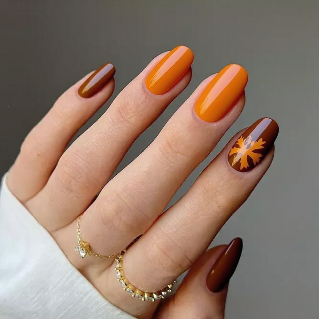 I want a pumpkin spice-inspired set—medium stiletto nails with an ombre from orange to brown and a tiny leaf decal.