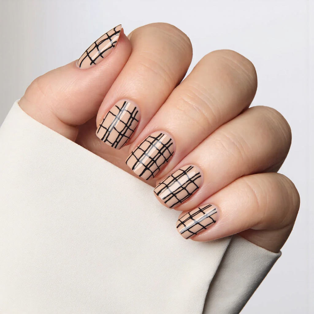 I'd love short square nails with a chic negative-space nail art design using bold black lines.