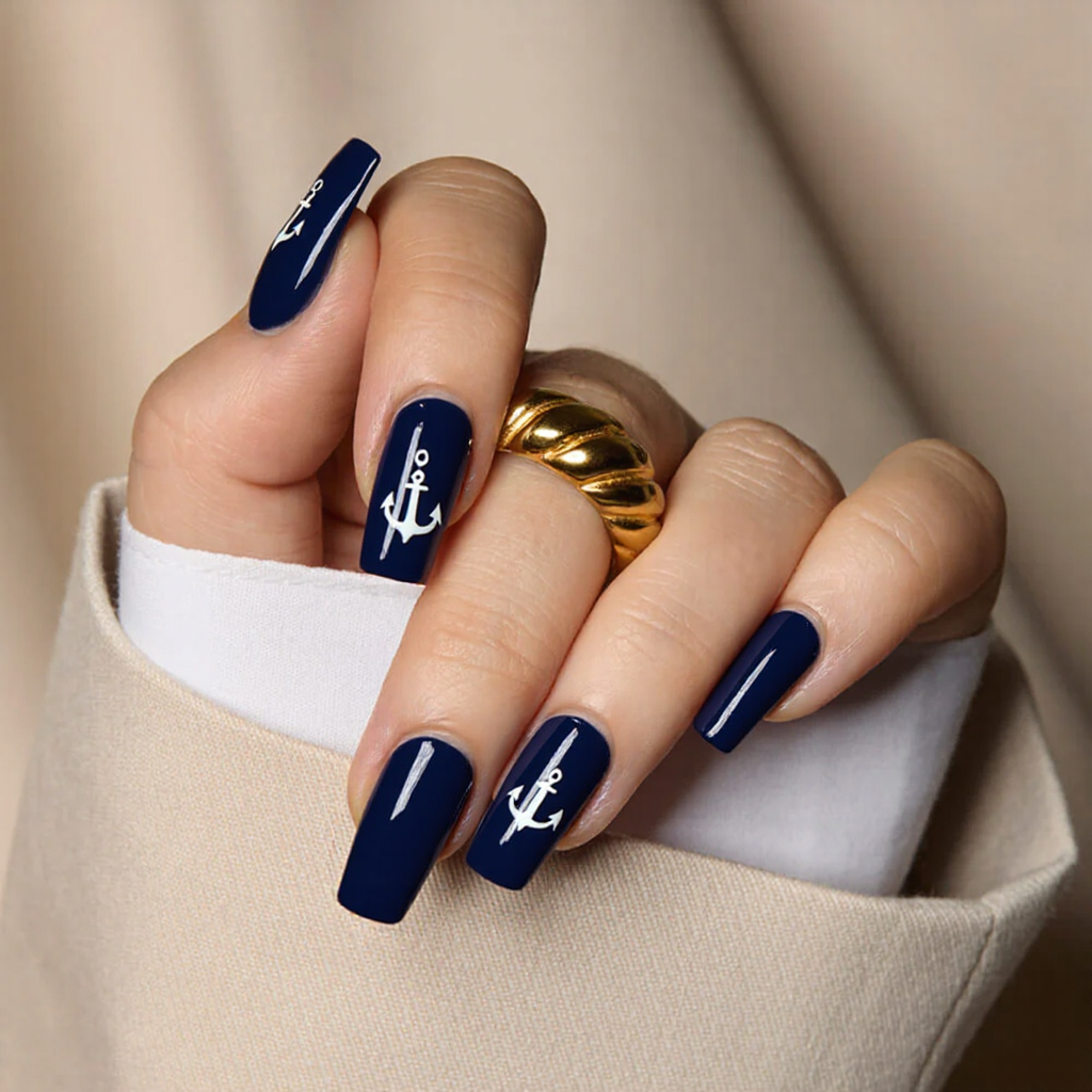 Medium square nails in a classic navy blue, each with a single white anchor decal for a nautical theme.