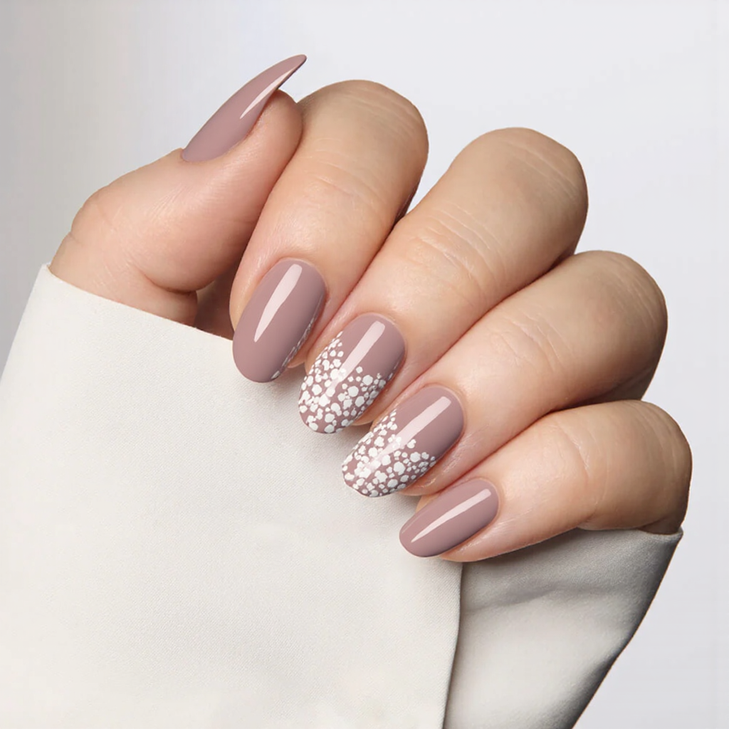 How about medium almond nails in dusty rose with a delicate white floral pattern on the middle nail?