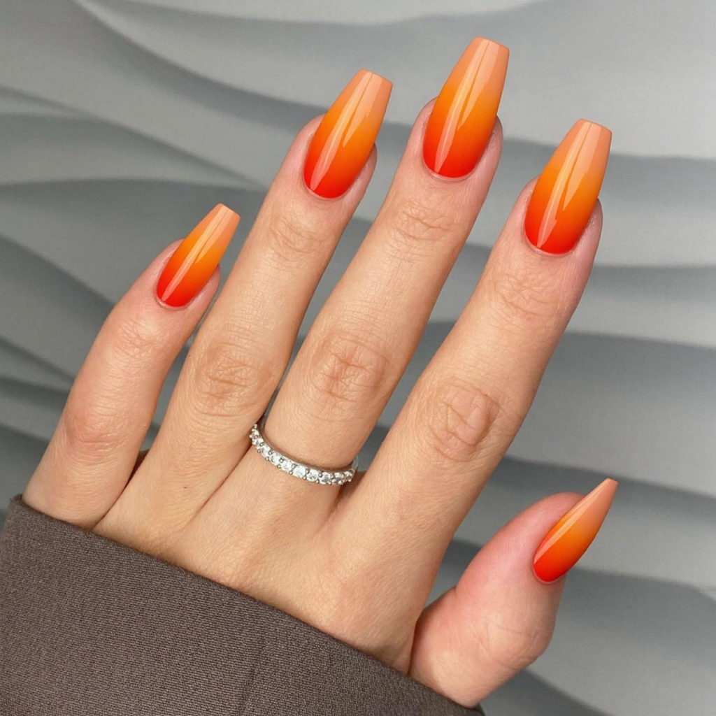 Long almond nails in a bright sunset gradient, perfect for tropical vacations and beach parties.