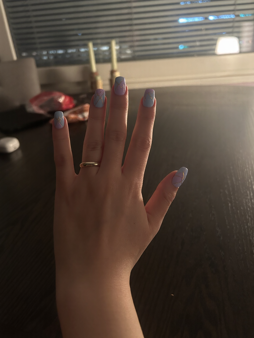 Create a stunning nail art design that showcases your love for pastel colors and geometric patterns on long stiletto-shaped nails. Imagine a playful mix of light blues, soft pinks, and gentle lilacs elegantly arranged in various geometric shapes like triangles, lines, and sharp angles. Consider adding a glossy finish to enhance the soft pastel hues and perhaps a touch of matte on certain shapes for a trendy contrast. You might also incorporate thin white lines or delicate gold accents to bring the geometric elements to life, creating a modern and chic look that is both eye-catching and sophisticated.