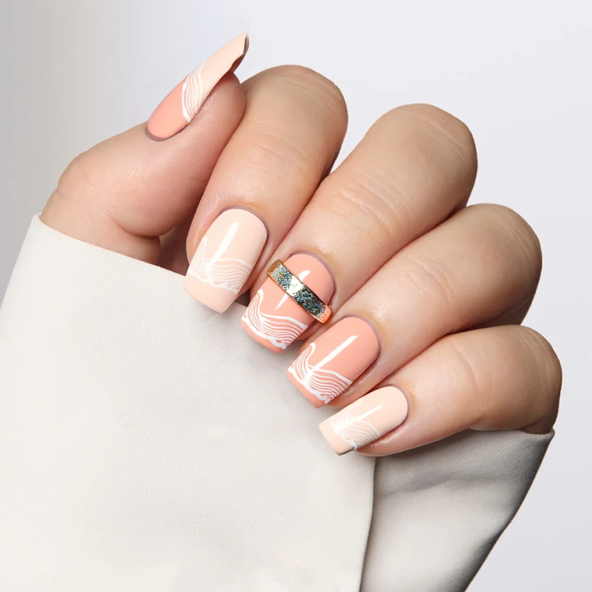 Nails adorned in a soft pastel peach base color, reminiscent of a warm summer sunset, creating a light and cheerful atmosphere. The middle and ring fingers feature delicate white hand-painted wave patterns flowing from the cuticle towards the tips, evoking a gentle ocean breeze. To add just a touch of shimmer, a fine scattering of iridescent glitter is placed along the waves, glistening like sunlit ocean water. The remaining nails are kept simple with the same peach base for a harmonious look, perfectly complementing the elegant almond shape of the medium-length nails.