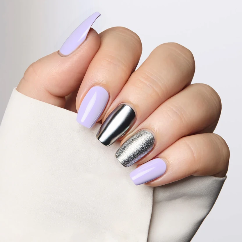 Nails adorned in a soft, light purple base color that exudes a playful and feminine vibe, perfect for a birthday celebration. The middle finger features a subtle chrome effect that catches the light beautifully, providing a sleek, reflective contrast against the delicate base. The ring finger showcases a minimal sprinkle of fine silver glitter, delicately scattered to create a twinkling effect without overwhelming the design. The remaining nails maintain the same light purple base, ensuring a cohesive look that elegantly complements the almond shape and medium size, resulting in a polished and celebratory nail art design.