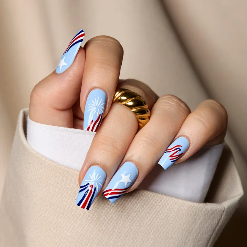Nails painted in a soft, pastel blue as the base color, providing a subtle backdrop for the festive design. The index and ring fingers showcase minimal white star patterns, reminiscent of fireworks, while the other nails remain plain to emphasize the accent. Delicate red and white stripes gently sweep across the tips of the middle finger, adding a whimsical touch to the overall look. Finished with a glossy top coat, this design captures the spirit of Independence Day in an elegant and feminine way, perfect for the medium square shape.