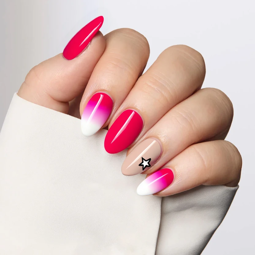 Nails feature a vibrant hot pink French tip that elegantly tops each almond-shaped nail, complemented by a nude base color that enhances their natural beauty. The middle finger showcases a soft pink aura effect extending gracefully from the base to the tips, adding a delicate and ethereal touch. On the ring finger, a classic white French tip stands out, adorned with a subtle hot pink star accent at the cuticle, lending an artistic flair to the design. The overall finish is glossy, ensuring a chic and polished look while maintaining a feminine and elegant aesthetic.